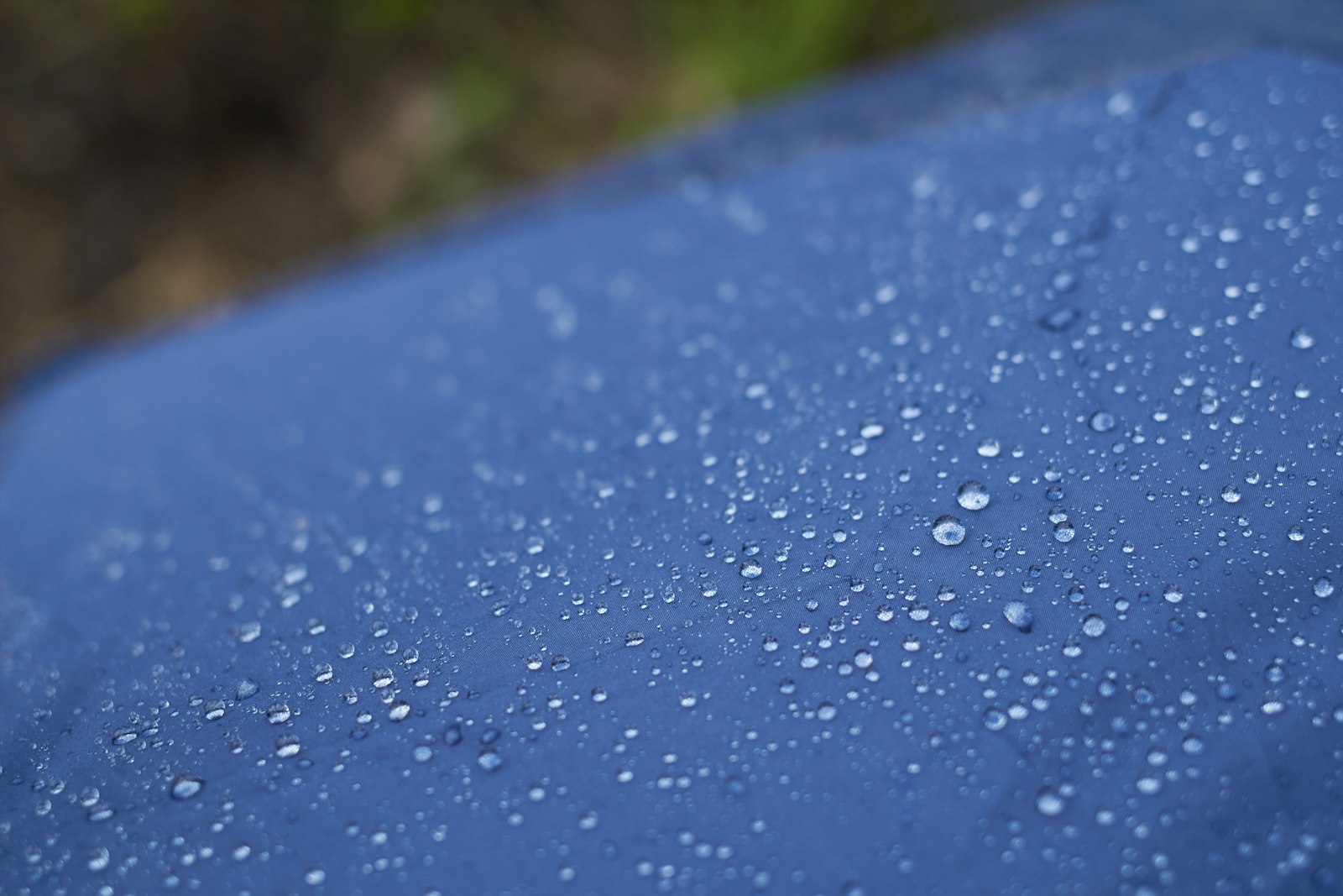 Gouttes d'eau perlant sur le tissu d'une veste imperméable